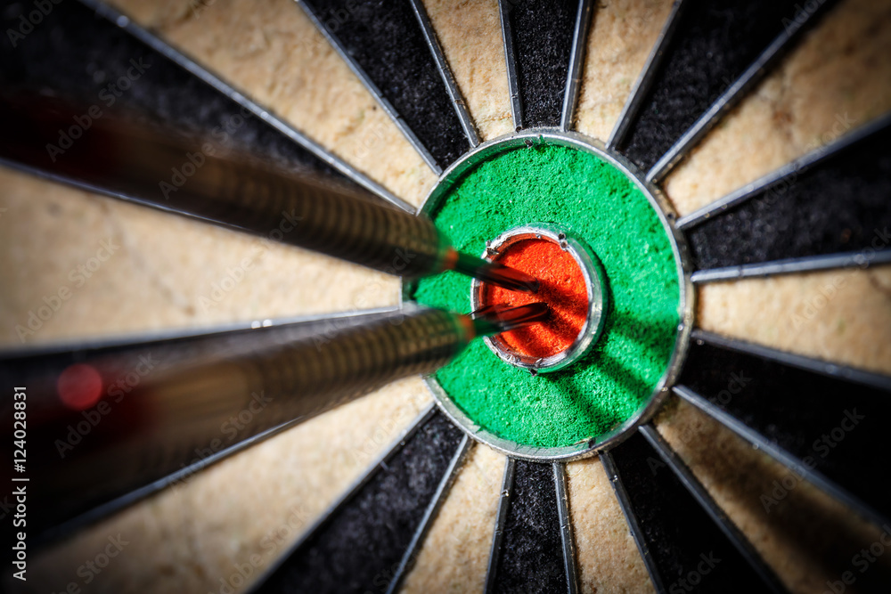three darts in bull's eye, close up three darts in bull's eye, close up
