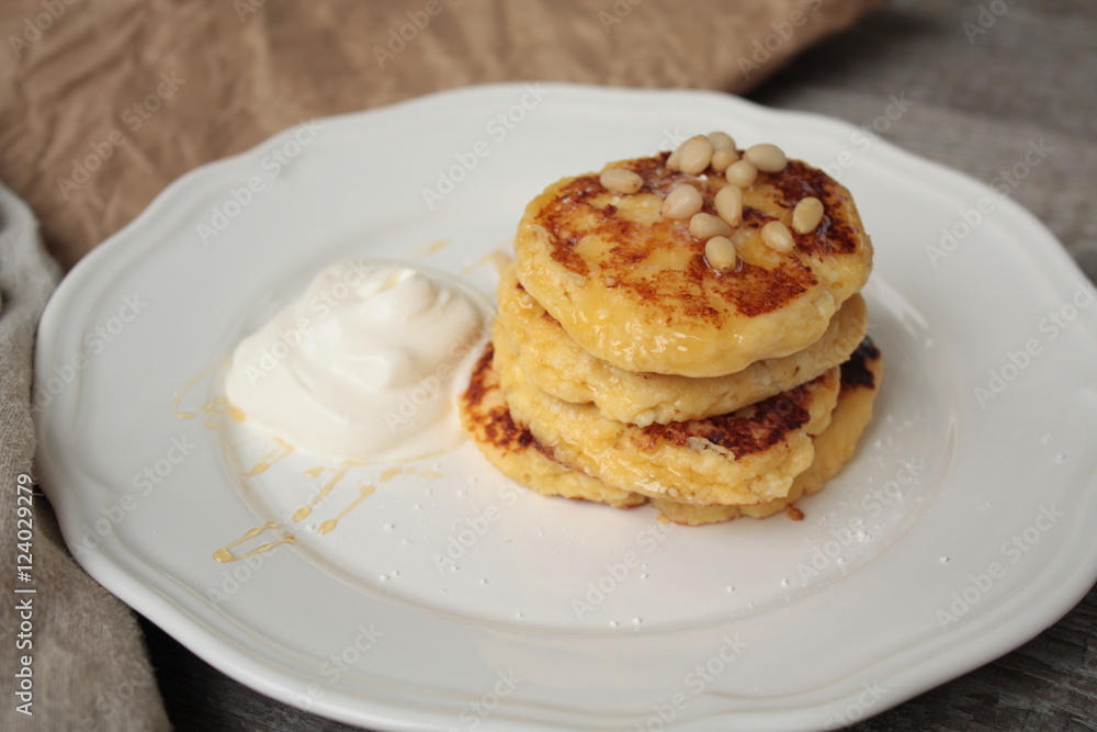Russian sweet cheese pancakes with sour cream for Breakfast or a snack - it's delicious