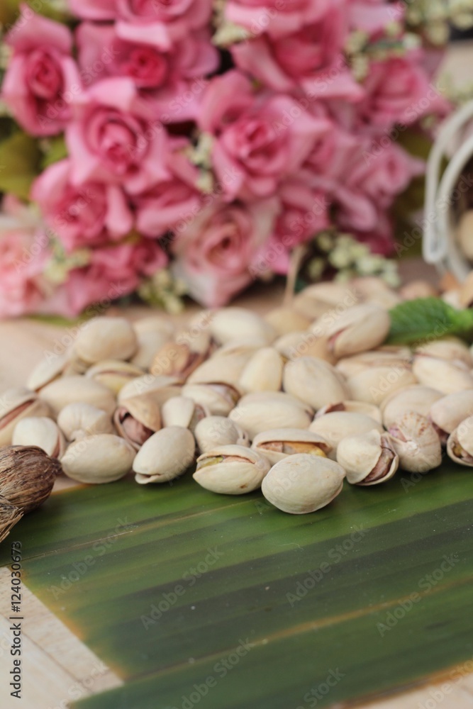 Pistachio nuts is tasty on wood background.