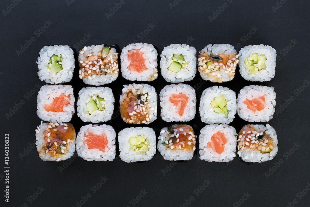 Mix of Japanese nori rolls in on a black background Mix of Japanese nori rolls in on a black background