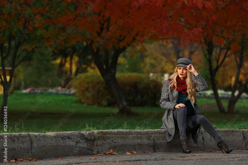 beautiful woman sits on the road in autumn park beautiful woman sits on the road in autumn park