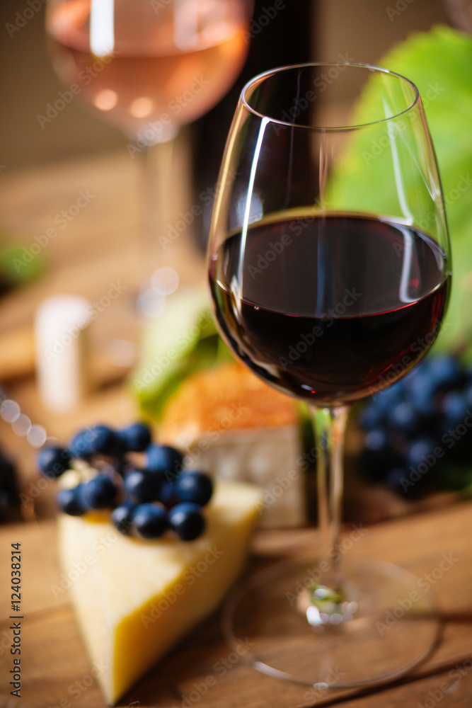 Glass of wine, grape and chesse on a table 