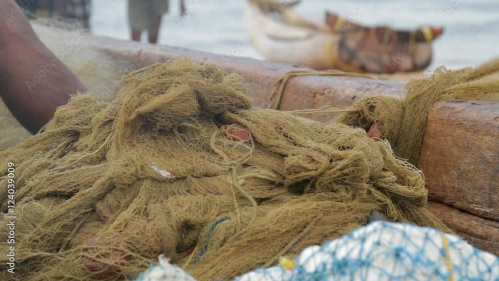 Close-up fishing nets being untangled. Close-up fishing nets being untangled.