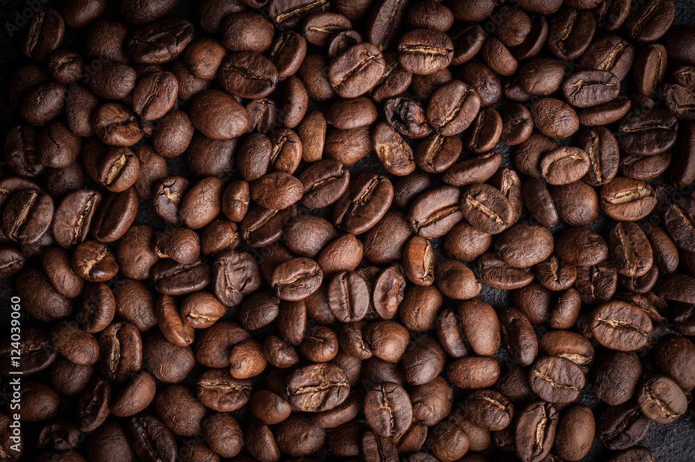 Obraz premium roasted coffee beans on dark background, can be used as a background