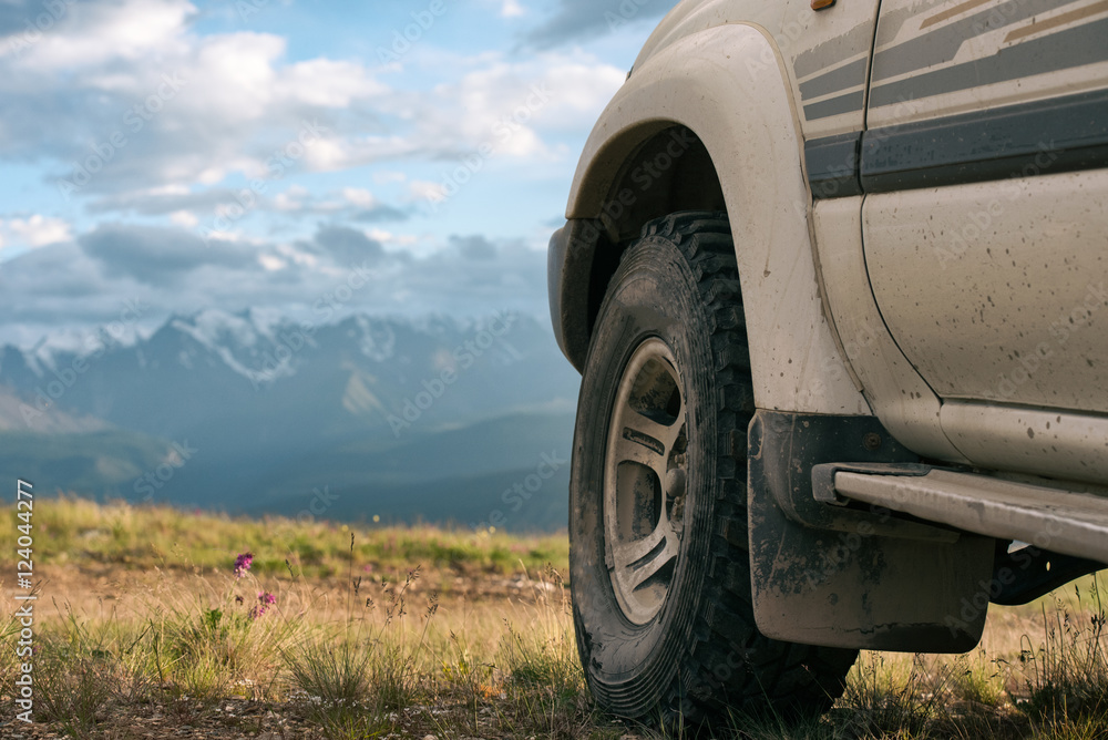 Offroad car concept with mountains. Wheel close-up. Offroad car concept with mountains. Wheel close-up.