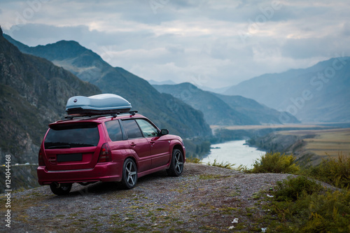 The car on the mountain road, the river. © kuzovkov