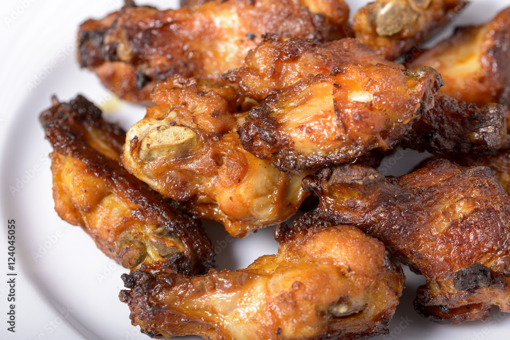 dish of spicy chicken wings on wood dish of spicy chicken wings on wood