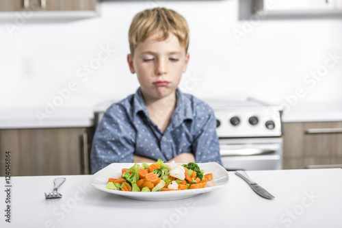 boring expression with fresh colorful vegetables child