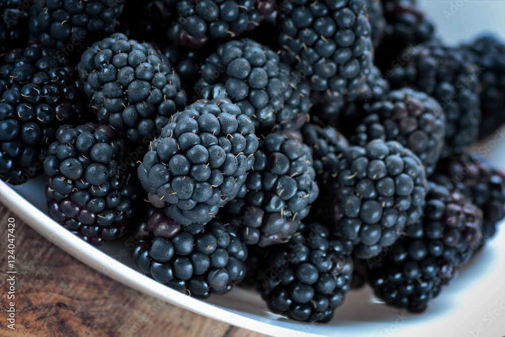 Fresh ripe blackberries in white bowl Fresh ripe blackberries in white bowl
