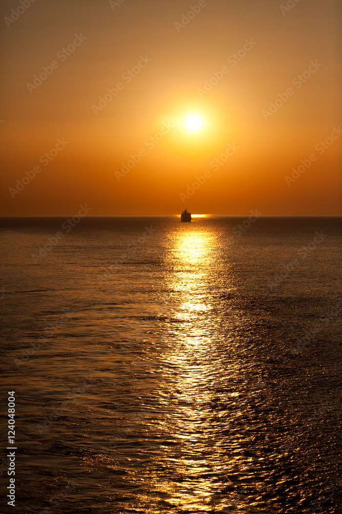 Sunset in Greece from a cruise ship. Small ship on background