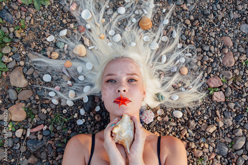 Young woman with seahells in hair. photo