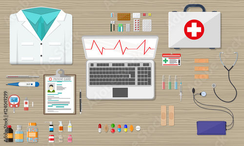 desk with laptop, medical and healthcare devices
