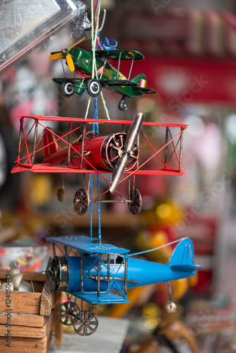 Close-up detail of colorful tin toy airplanes at a toy shop.