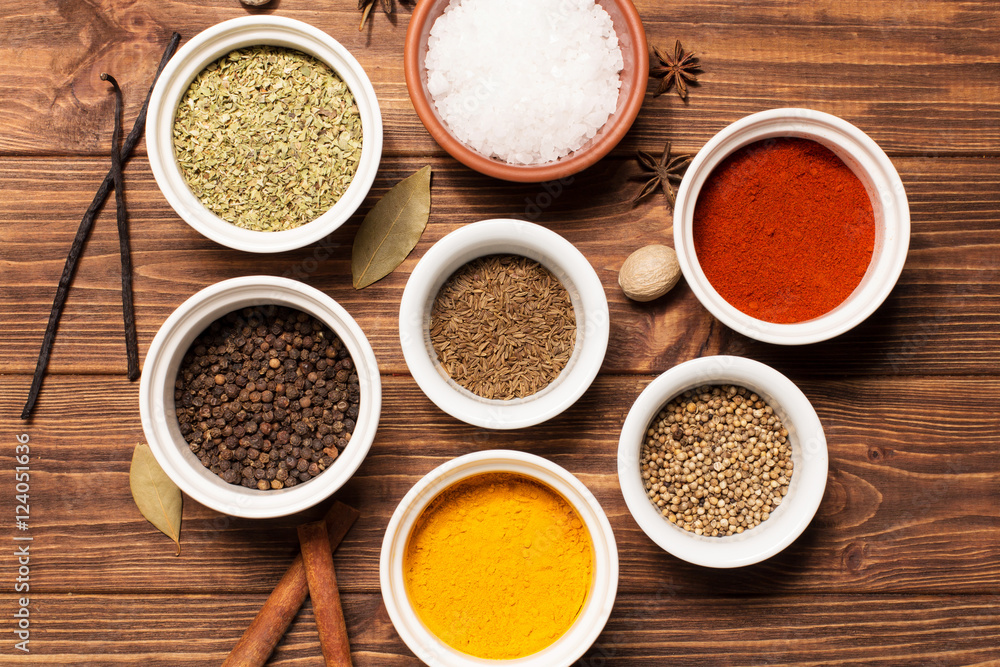Spices on brown rustic wooden background, soft focus, horizontal
