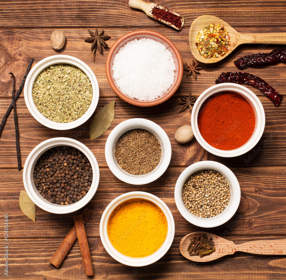 Spices on brown rustic wooden background, soft focus, square
