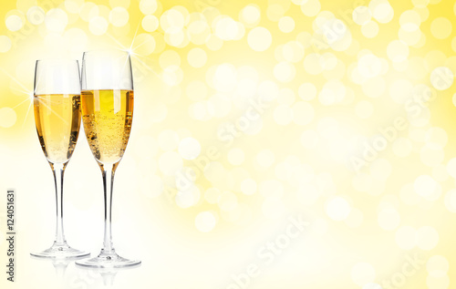 Two champagne glasses over christmas background
