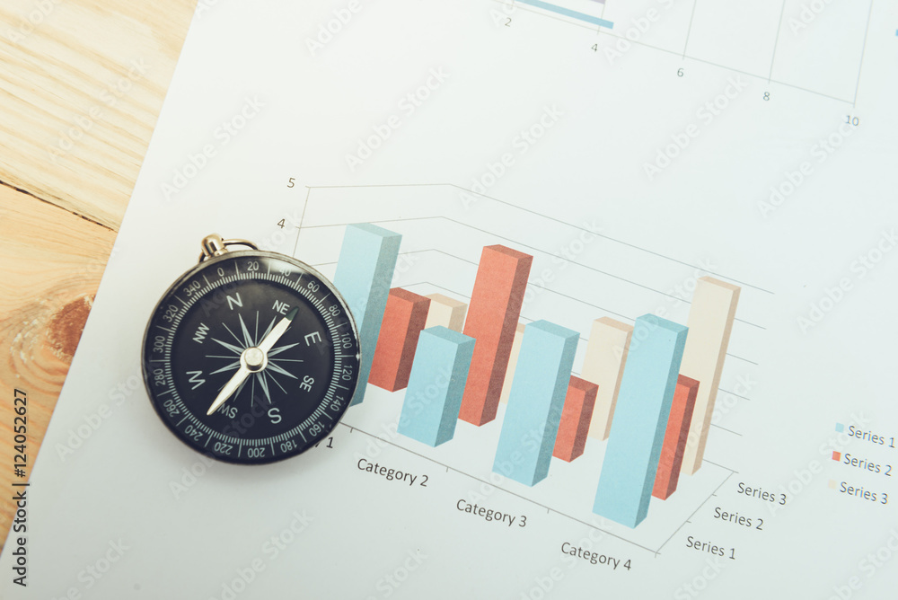 business navigation concept with compass and diagram or graph business navigation concept with compass and diagram or graph