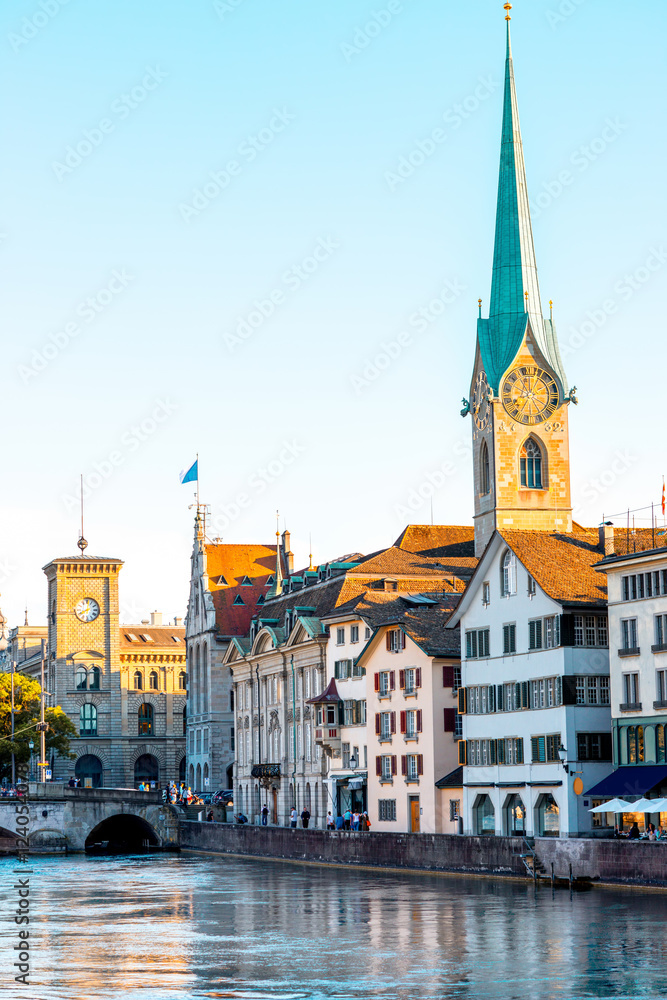Sunset view on the riverside with beautiful buildings and church tower in Zurich in Switzerland