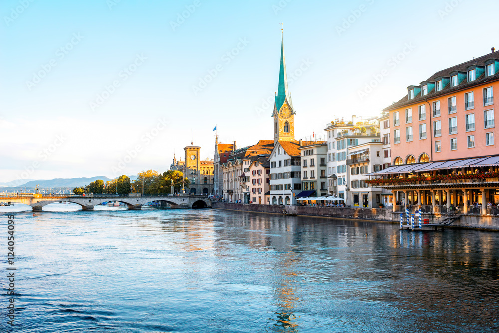 Sunset view on the riverside with beautiful buildings and church tower in Zurich in Switzerland