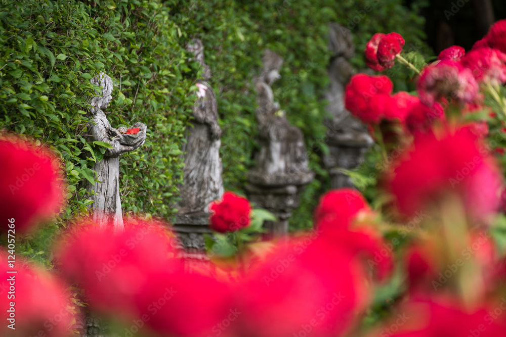 statues with green leaves background in garden