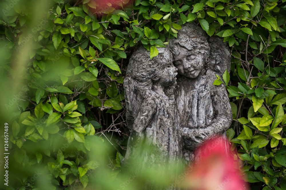 statues with green leaves background in garden