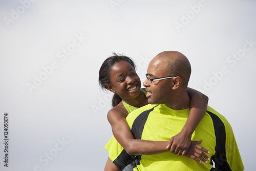 Father And Daughter Having Fun Together Outdoors; Edmonton, Alberta, Canada photo