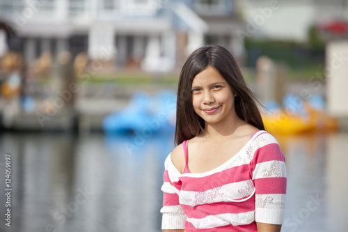 Teenage Girl On Lakeshore Of Residential Lake; Edmonton, Alberta, Canada photo