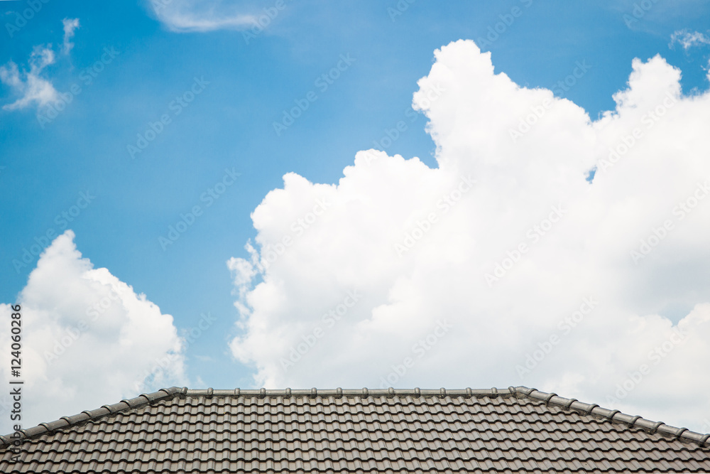 Beautiful a group of clouds in the blue sky and roof top of modern home during the sun shin. Beautiful a group of clouds in the blue sky and roof top of modern home during the sun shin.