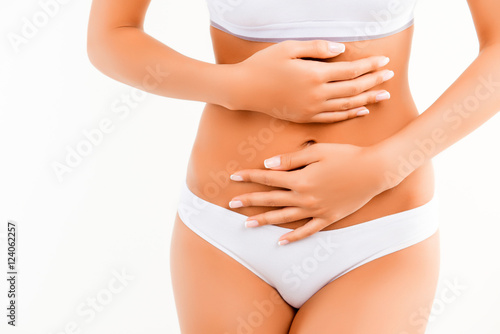 Woman suffering from stomach pain isolated on white background