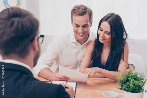 Successful lawyer giving consultation to family couple about buy photo