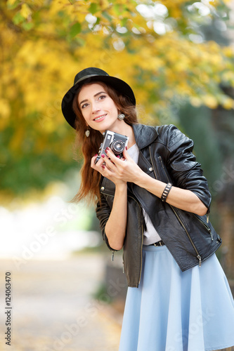Young girl with camera outdoors
