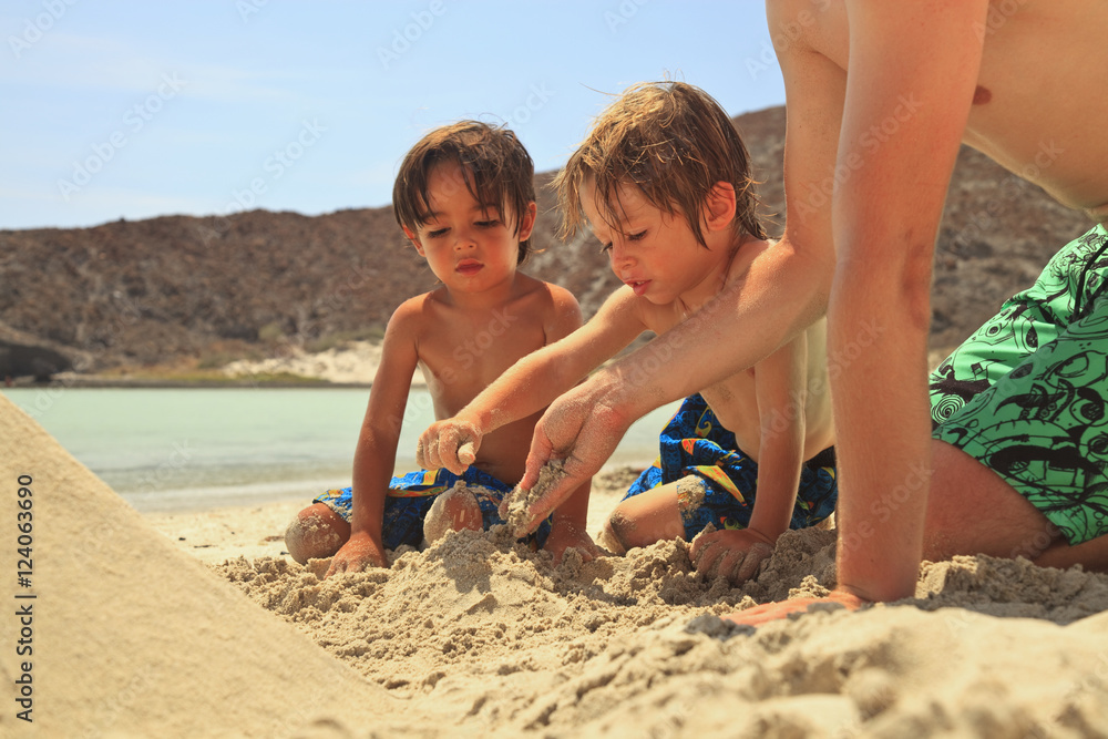 Three Boys Play In The Sand At The Water's Edge At Los Islotes National Marine Park Espiritu Santo Island; La Paz, Baja, California, Mexico Three Boys Play In The Sand At The Water's Edge At Los Islotes National Marine Park Espiritu Santo Island; La Paz, Baja, California, Mexico