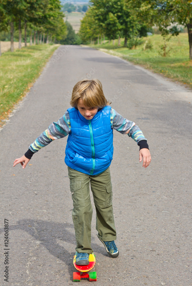 little boy having fun with skateboard outdoors. little boy having fun with skateboard outdoors.