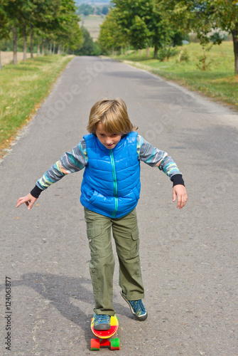 little boy having fun with skateboard outdoors. © fototvv