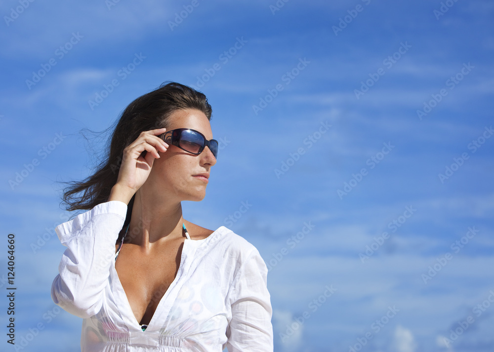 Portrait Of A Woman Wearing Sunglasses Against A Blue Sky; Punta Cana