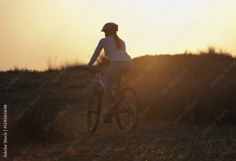 A Cyclist Rides On A Path At Sunset; Tarifa, Cadiz, Andalusia, Spain A Cyclist Rides On A Path At Sunset; Tarifa, Cadiz, Andalusia, Spain