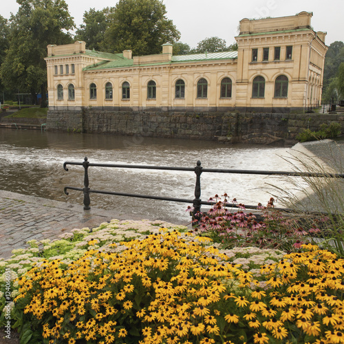 Fyris River And Pump House With Colourful Flowers In The Foreground; Uppsala, Sweden photo