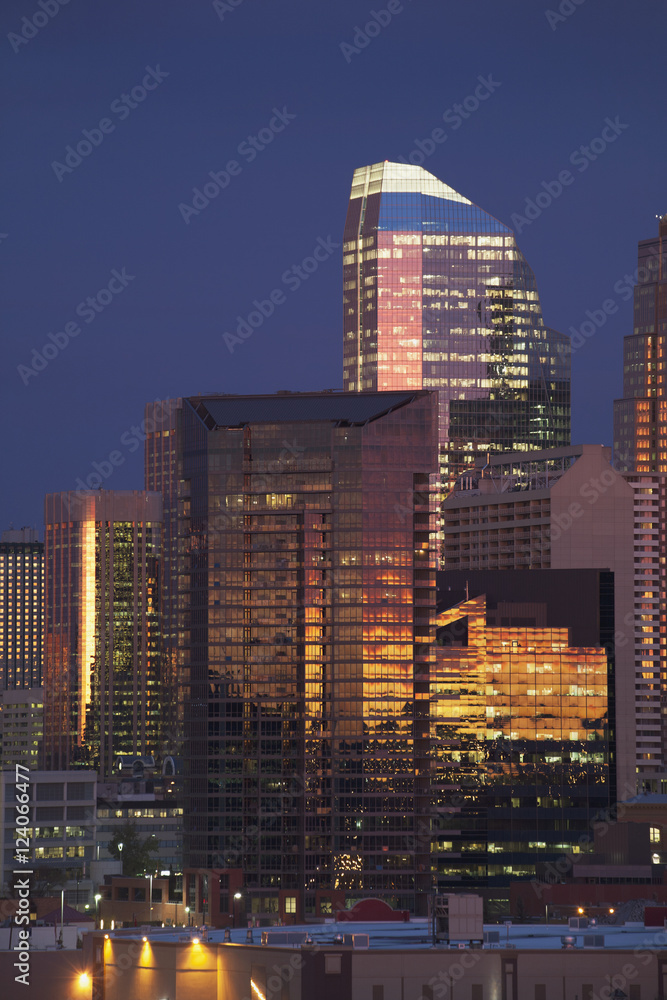 Calgary Skyline At Dawn With City Lights And Deep Blue Sky With Buildings Reflecting The Orange Glow Of Sunrise; Calgary, Alberta, Canada Calgary Skyline At Dawn With City Lights And Deep Blue Sky With Buildings Reflecting The Orange Glow Of Sunrise; Calgary, Alberta, Canada
