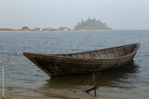 Wooden boat on the lake. Lake Baikal, Chivyrkuisky Bay, Buryatia, Russia.
