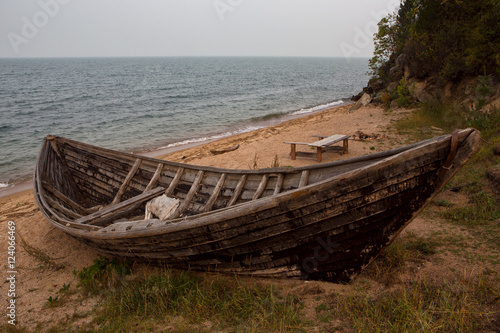 Wooden boat on the lake. Lake Baikal, Chivyrkuisky Bay, Buryatia, Russia.