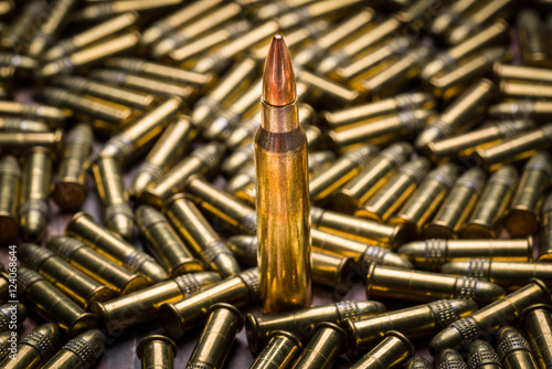 Selective focus on a single 223 caliber bullet in a background o photo