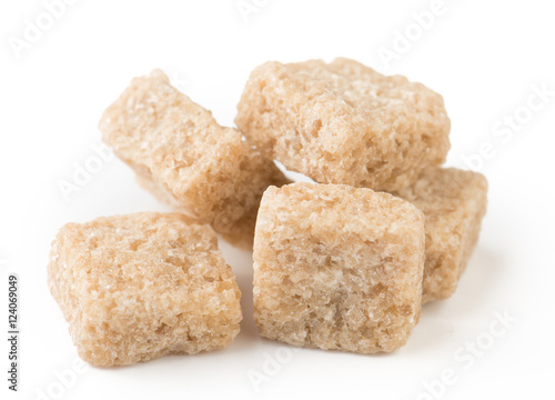 pieces of brown cane sugar isolated on white background.