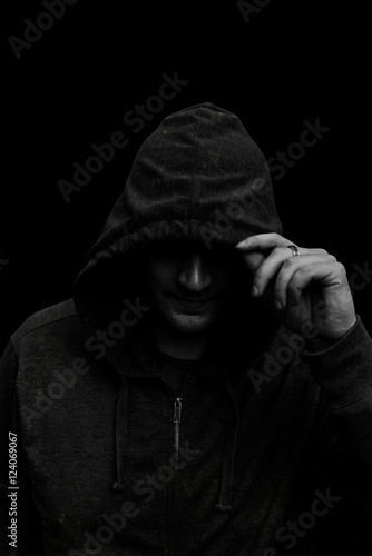 Black and white Silhouette of a hooded man, isolated on black ba