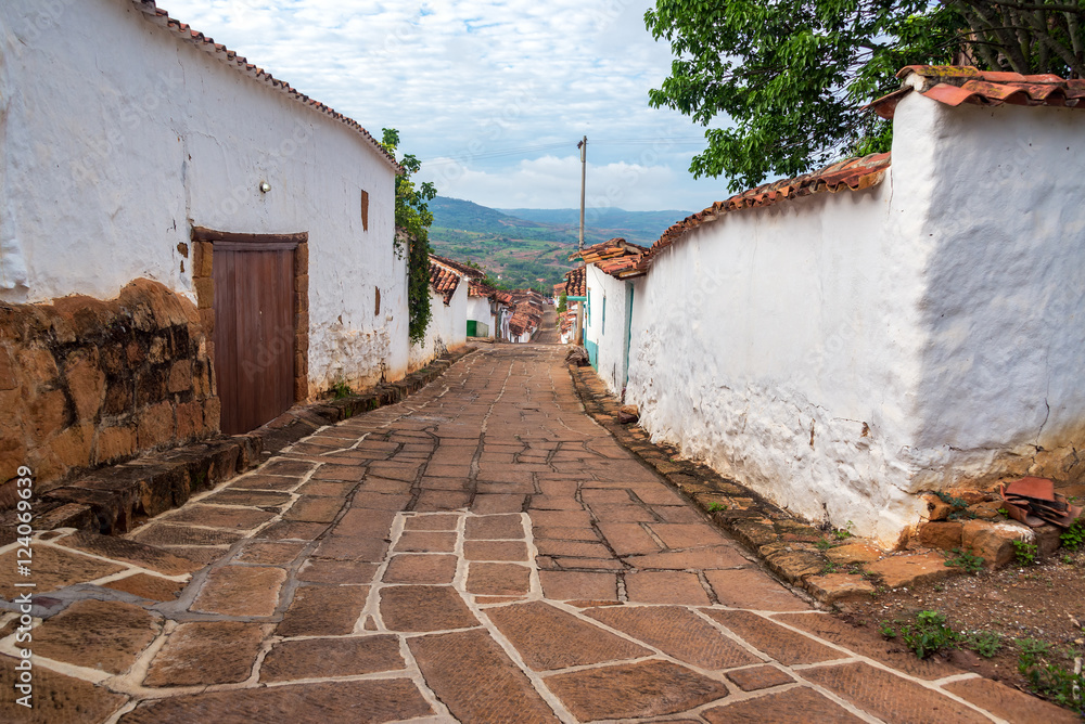 Looking down a street lined with beautiful colonial architecture in Barichara, Colombia