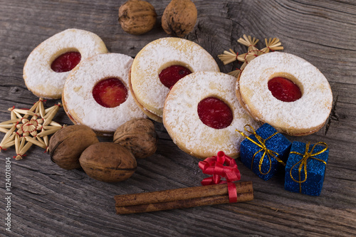 Homemade Christmas sweets with sugar powder and jam on old woode
