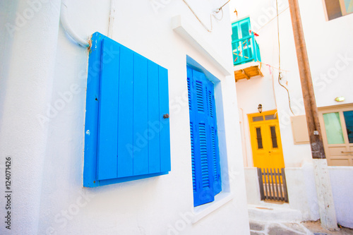 Traditional houses with colorful doors in the narrow streets of Mykonos, Greece. © travnikovstudio