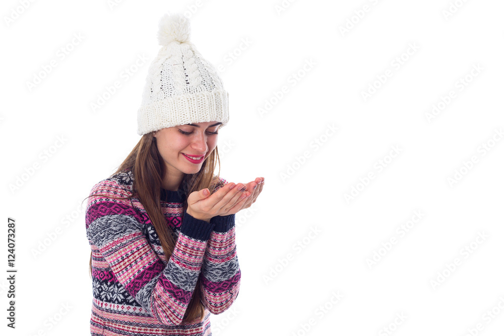 Woman in sweater and white hat holding something Woman in sweater and white hat holding something