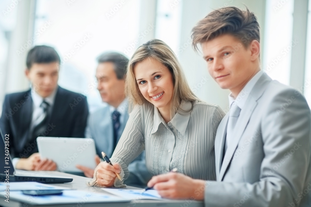 a friendly and successful business team in a workplace a friendly and successful business team in a workplace