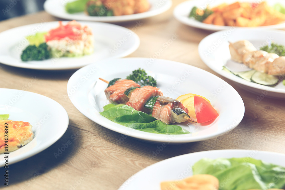 kebab plates with salad on table in restaurant..