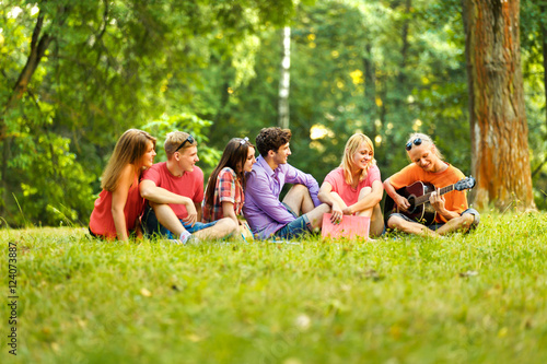  group of students with a guitar resting in the Park  © yurolaitsalbert